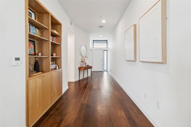 Corridor featuring dark wood-type flooring, baseb