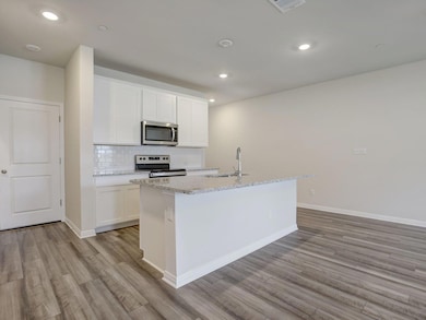 Kitchen featuring stainless steel appliances, a s