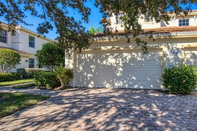 View of front facade with a garage and decorative