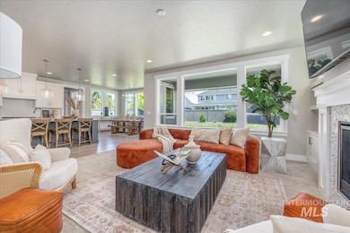 Living area with recessed lighting and a glass covered fireplace