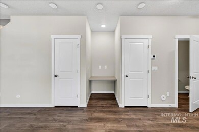 Unfurnished bedroom featuring a textured ceiling, dark wood-style flooring, and recessed lighting