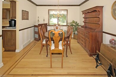 Hardwood with inlay.  Crown molding and chair rail