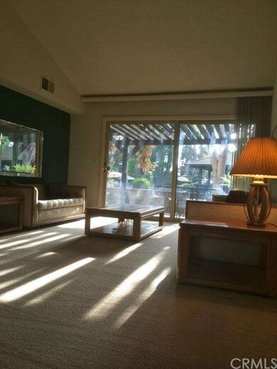 living room with open view of stream, community po