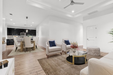 Virtually staged living and dining rooms.