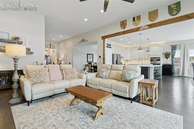 Large living room with open floor plan, recessed lighting, hardwood flooring. Real wood beams.