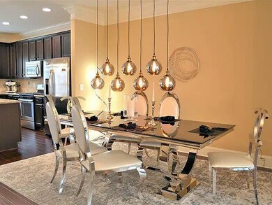 Dining space with dark wood finished floors, baseboards, ornamental molding, and recessed lighting