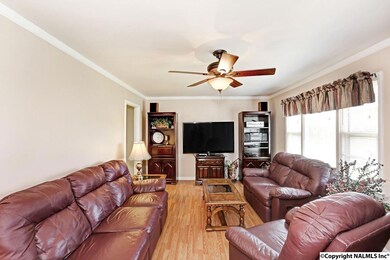 With laminate floors, ceiling fan and crown mold.