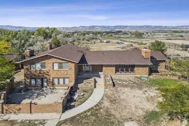View of front of house featuring a chimney, a mountain view, and brick siding