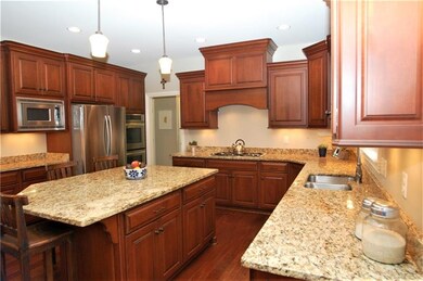 Custom cabinetry, oversized granite center island,