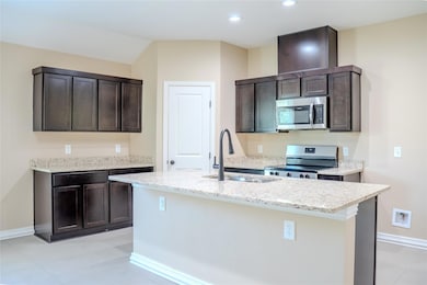 Kitchen featuring appliances with stainless steel