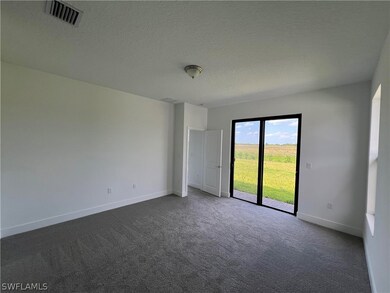 Carpeted spare room featuring a textured ceiling