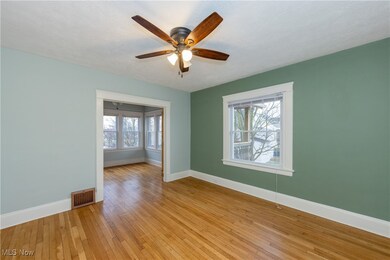 Unfurnished room featuring a textured ceiling, light wood-type flooring, and ceiling fan