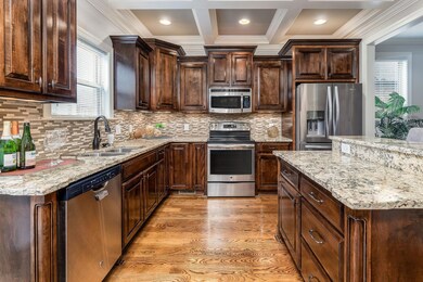 Coffered Ceiling, Granite Counters, & Stainless Appliances in Kitchen
