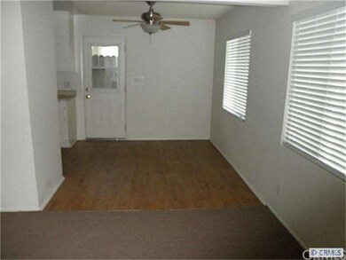 Living room into dining area with ceiling fan