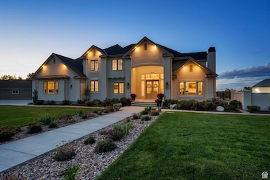 View of front of house featuring a yard, a chimney, and stucco siding
