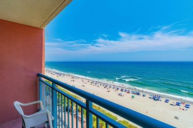 Balcony with a water view and a view of the beach