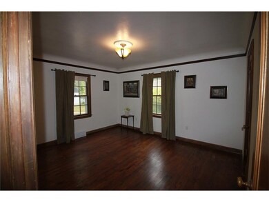 Master bedroom on the main floor with hardwood flo