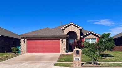 View of front of home with a garage and a front la