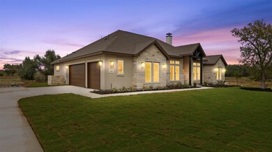 View of front of home with stone siding, a chimne