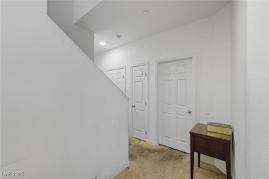 Hall featuring light colored carpet and recessed lighting