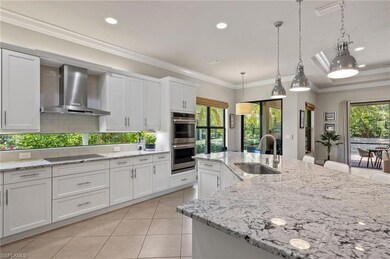 Kitchen featuring wall chimney range hood, stainle