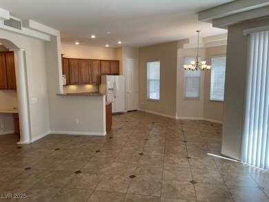 Kitchen featuring brown cabinetry, visible vents,