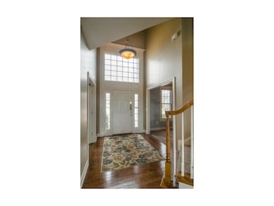 Striking 2 Story Entry With Hardwood Floors and Ne