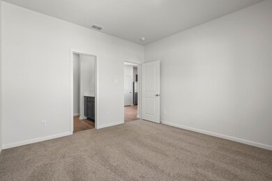 Unfurnished bedroom featuring carpet flooring and ensuite bathroom