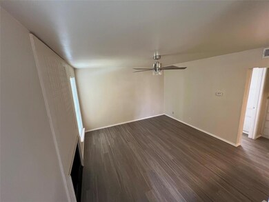 Empty room featuring dark wood finished floors an