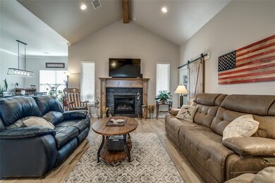 Living room with light wood-type flooring, beam ce