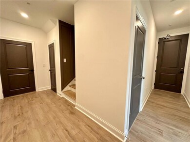 Guest Enter from the right door and walk around your foyer to the stairs to the upper level bedroom. Garage located to the door on the left *Photo from decorated model. Same Plan, Different Unit.*