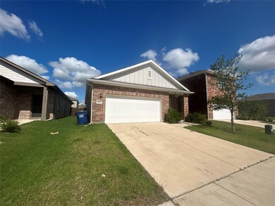 View of front facade with a garage and a front yard