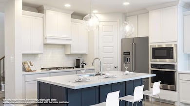 Kitchen with stainless steel appliances, a sink, 