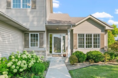 Inviting covered entry and maintenance free siding w/ brick accents