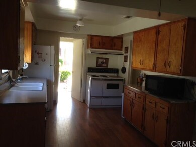 THE KITCHEN IS SPACIOUS WITH LAMINATE FLOORS