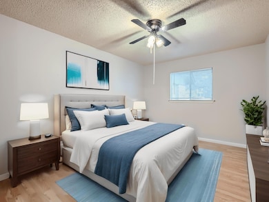 Bedroom with a textured ceiling, baseboards, a ce