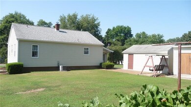 The rear yard showing garage, shed, and patio pave