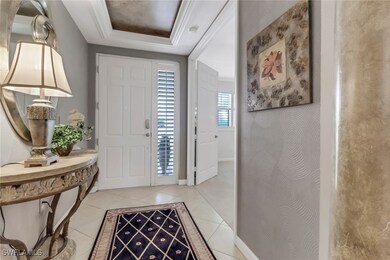 Tiled foyer featuring a raised ceiling