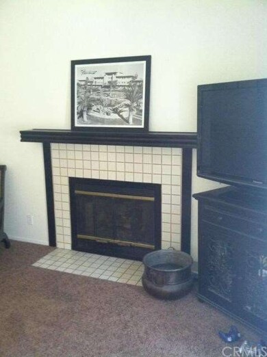 The spacious living room features a cozy fireplace