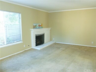 Spacious, bright living room has fireplace and cro