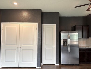 Kitchen featuring dark wood finished floors, stai