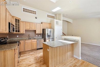 Kitchen with a sink, light wood-type flooring, bas