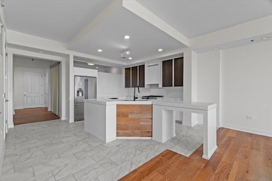 Kitchen featuring high end fridge, recessed lighti