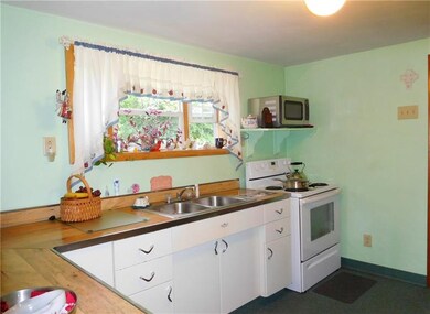 Cute and cheery kitchen.  Electric stove and mircr