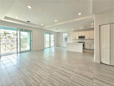 Unfurnished living room with a raised ceiling, bas