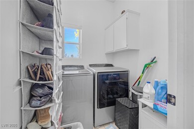 Washroom with cabinet space and washer and clothes