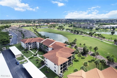 Aerial view of residential area featuring a large body of water and a local golf course