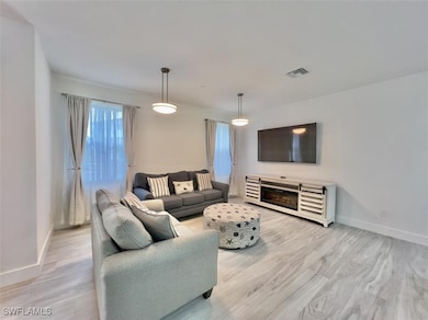 Living room featuring baseboards and light wood-st