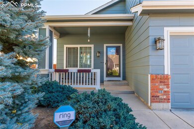 View of exterior entry with a garage and a porch