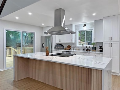 Chefs Kitchen with Oversized Island with Waterfall Quartz Countertops